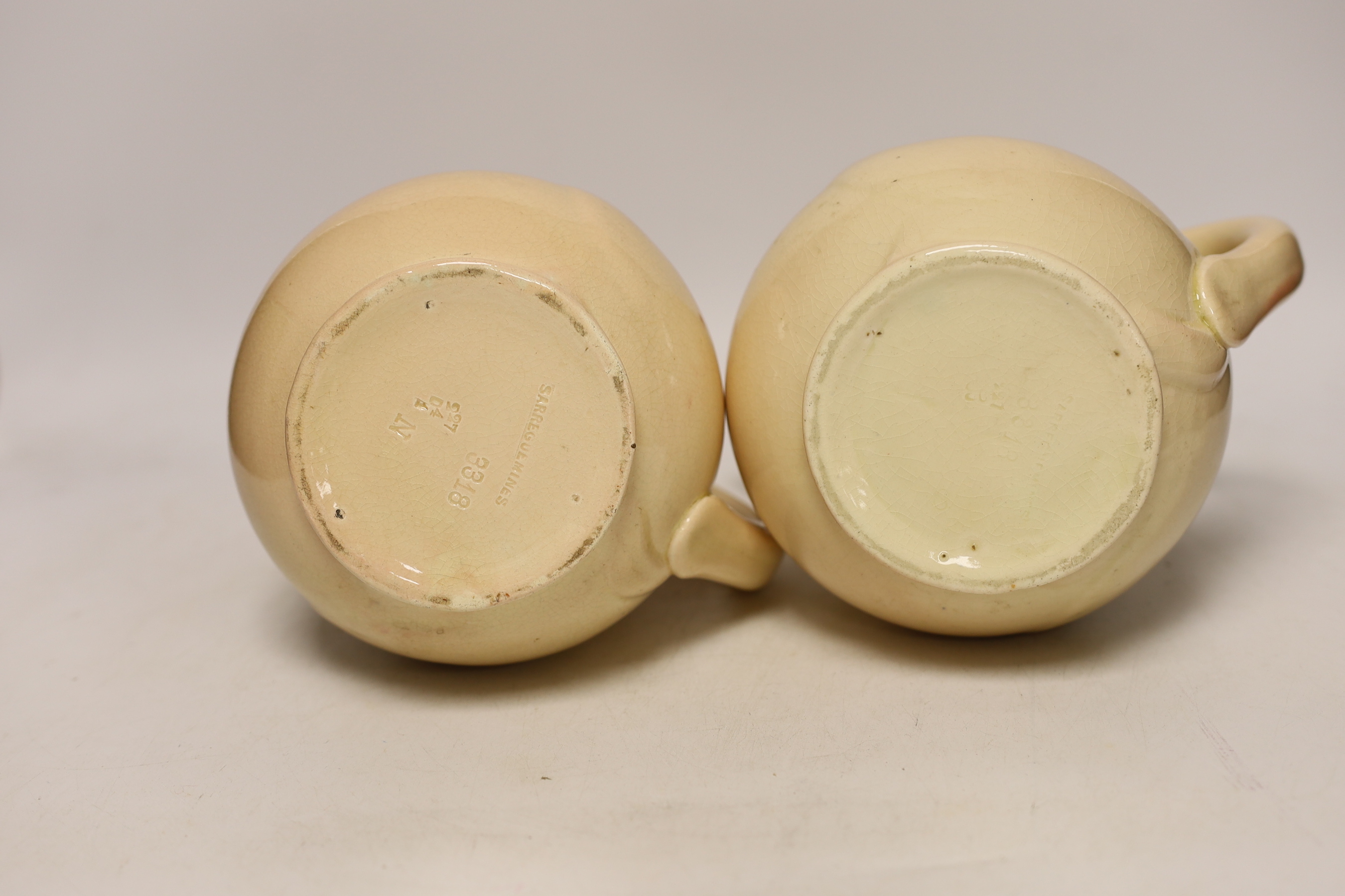 A pair of Sarreguemines ‘pig’ jugs, impressed numbers 3318 to each, 24cm